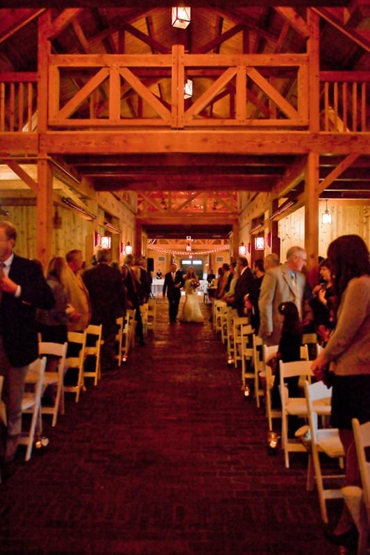 barn wedding bride walking down aisle