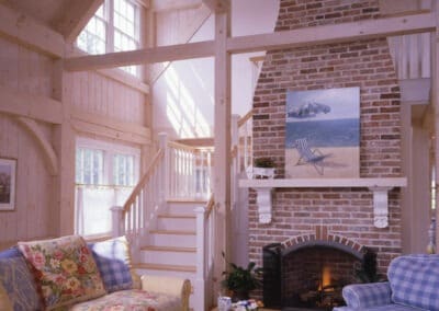 Orleans Guest House great room with timber framing and brick fireplace