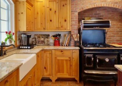 5066 Florence Cottage kitchen with rustic range surrounded by brick