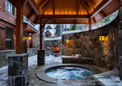 A stone hot tub on covered patio