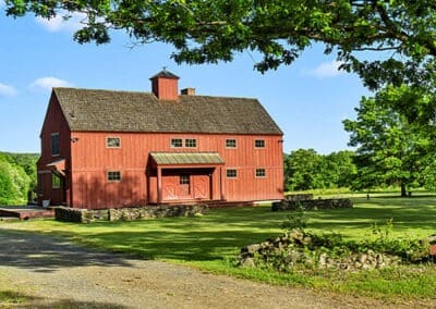 exterior view of red barn home with cupola