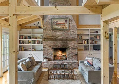 great room featuring cathedral ceiling and brick fireplace