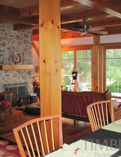 Sassafras River (5166) dining room and sitting area with stone fireplace and large windows looking out onto the waterfront
