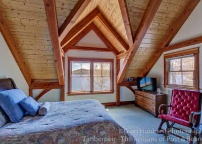 Birch Point T00352 bedroom with timber frame ceiling and view over water of lake sunapee