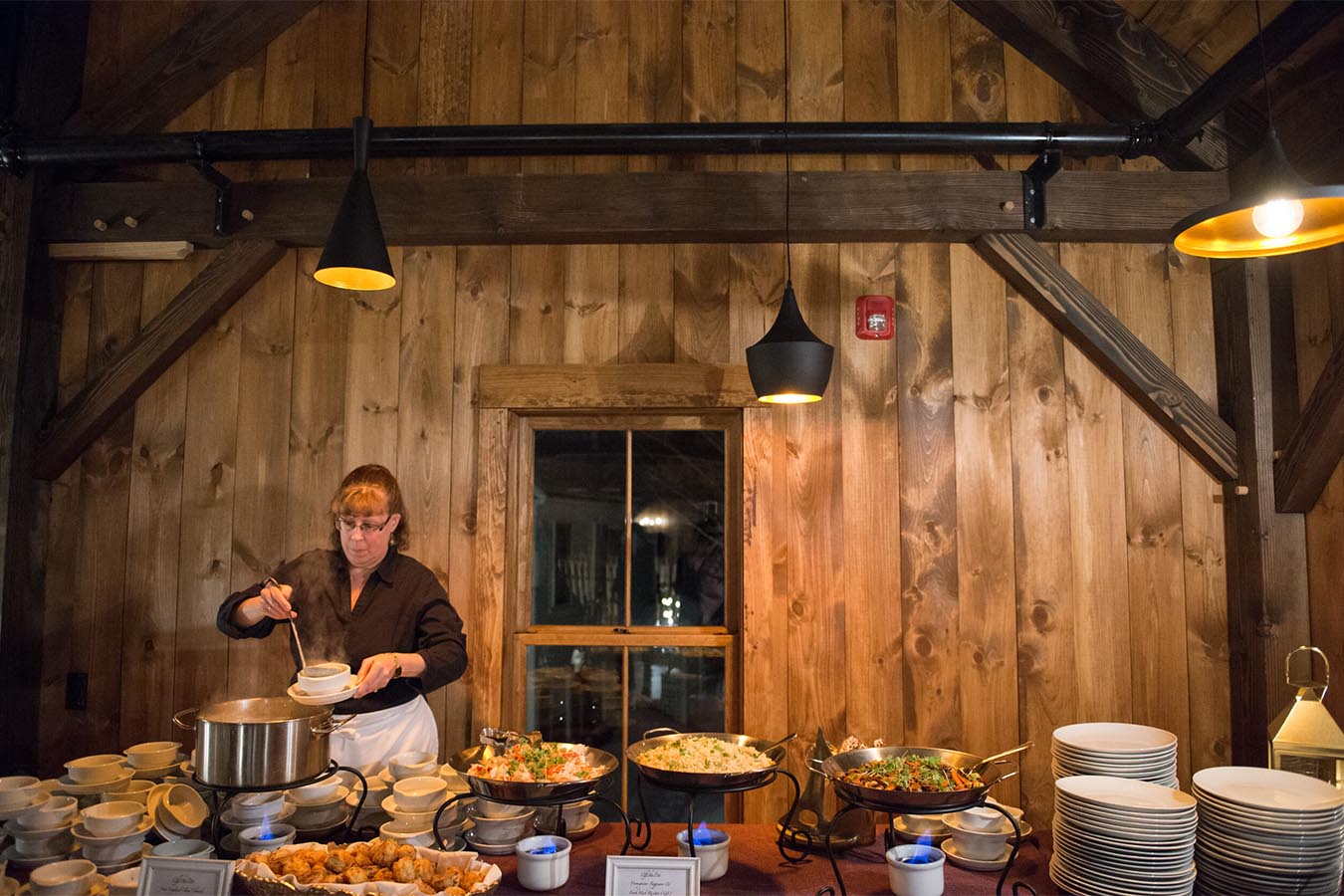 Caterer dishes out soup during an event.