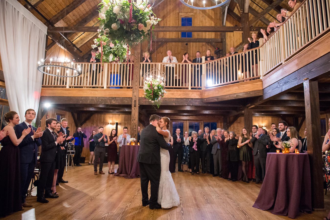 Bride and Groom dance while wedding guests look on