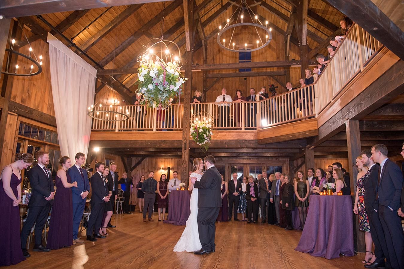 Bride and Groom dance while wedding guests look on