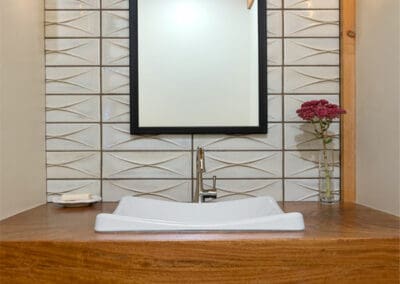 Bathroom sink with rectangular mirror above