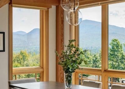 dining room with surrounding windows looking onto the mountains